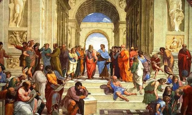Obra prima de Rafael Sanzio. Ao centro e ao alto, Platão à esquerda, usando toga vermelha, dialoga com Aristóteles, vestindo uma toga azul. Imagem: Reprodução.