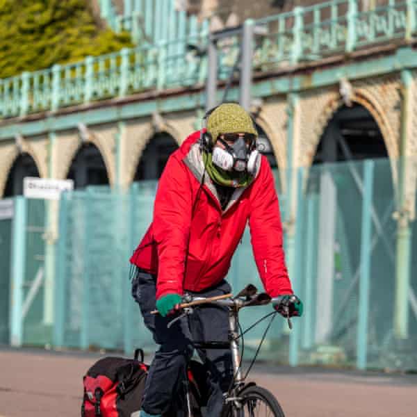 Ciclista com máscara protetora, pedala na Madeira Drive em Brighton, Reino Unido. Foto: Jon Santa Cruz / REX / Shutterstock